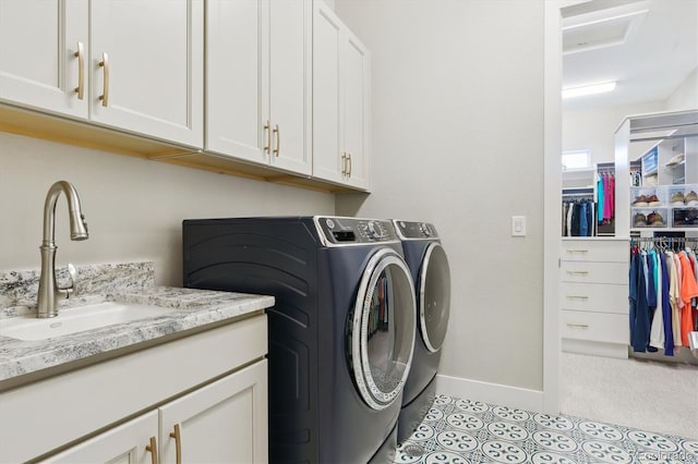 547 Scrubjay Cir, Castle Rock, CO 80104 - laundry area featuring cabinet space, washer and dryer, light tile patterned floors, and light colored carpet