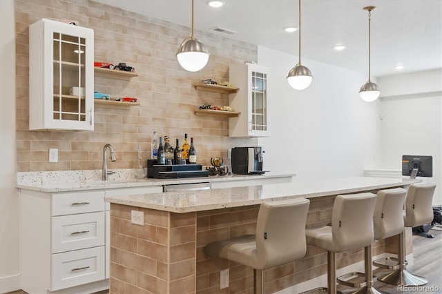 547 Scrubjay Cir, Castle Rock, CO 80104 - bar with decorative backsplash, hanging light fixtures, light wood finished floors, and recessed lighting