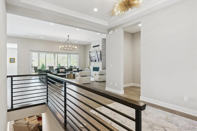 547 Scrubjay Cir, Castle Rock, CO 80104 - stairway with wood finished floors, a chandelier, recessed lighting, crown molding, and a stone fireplace