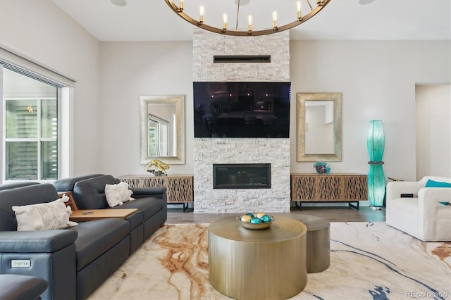 547 Scrubjay Cir, Castle Rock, CO 80104 - living room with a stone fireplace, wood finished floors, radiator heating unit, and a chandelier