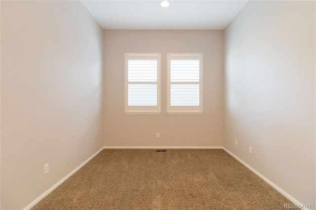 carpeted empty room with baseboards