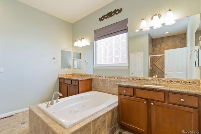 full bath with a tub with jets, a stall shower, visible vents, and a sink