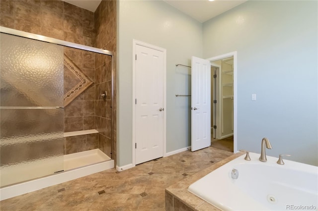 full bathroom with a sink, a tub with jets, and a shower stall