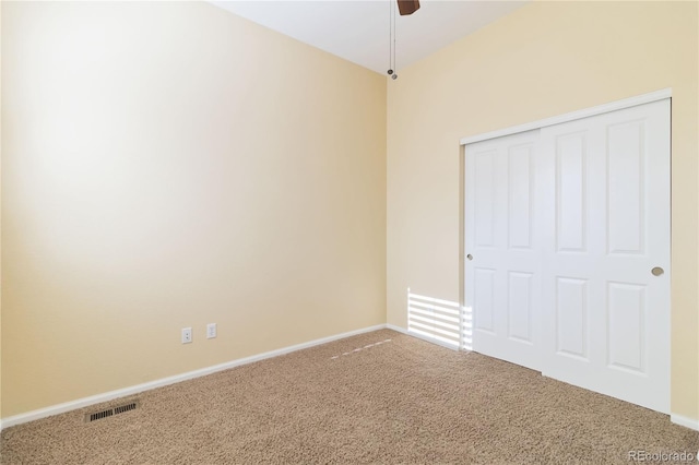 unfurnished room with carpet flooring, ceiling fan, baseboards, and visible vents