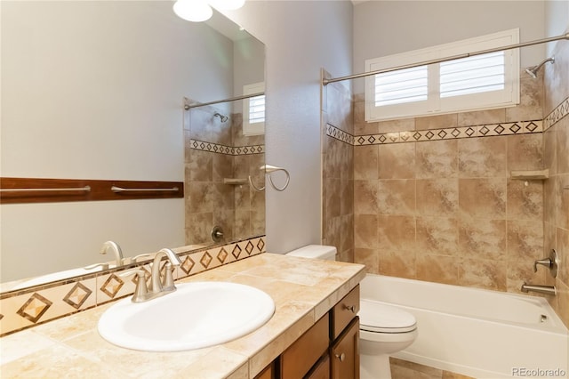 bathroom featuring vanity, shower / bathing tub combination, and toilet