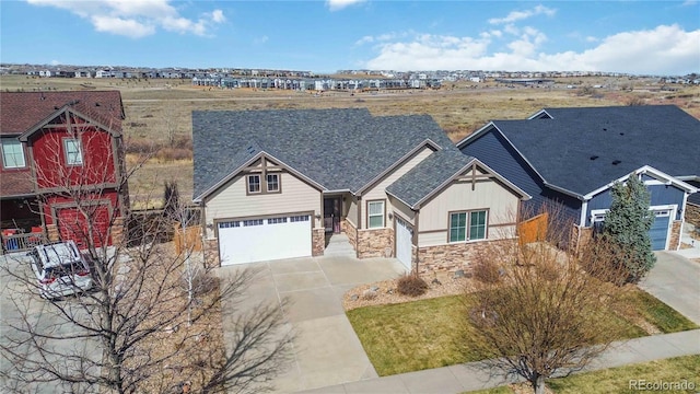 view of front of home with stone siding, a garage, driveway, and board and batten siding