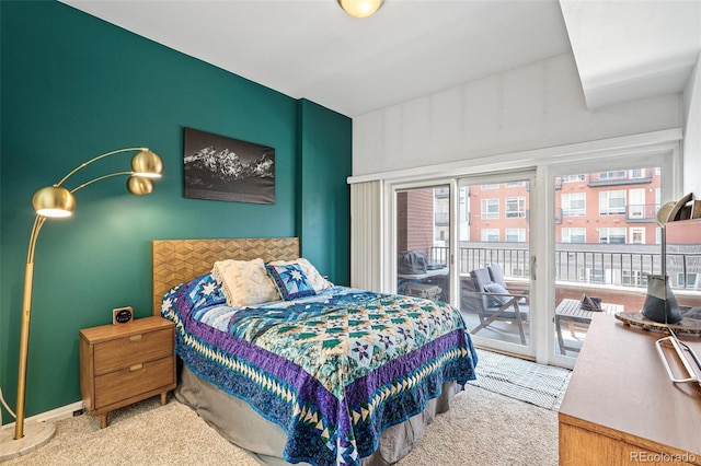 bedroom featuring access to outside and light colored carpet