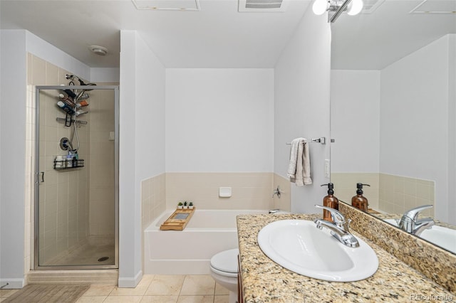 full bathroom with vanity, toilet, tile patterned floors, and independent shower and bath