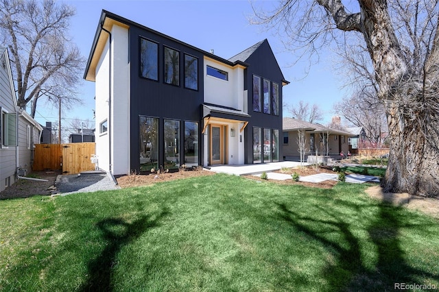 rear view of house with a lawn