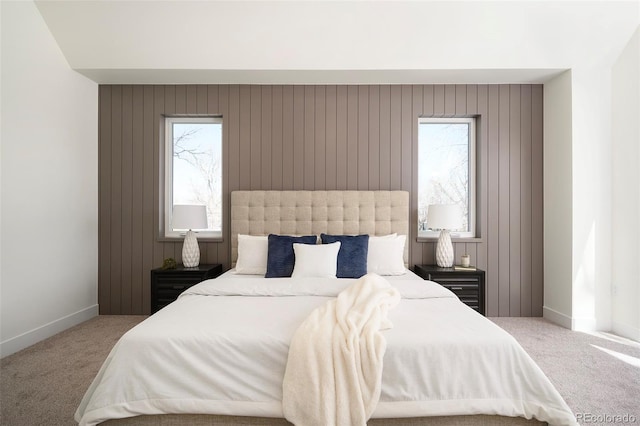 bedroom featuring light colored carpet and multiple windows