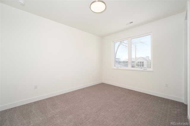 unfurnished room featuring dark carpet