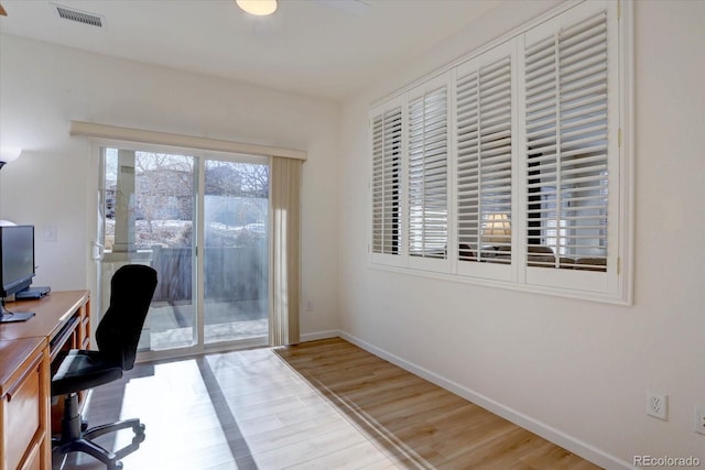 home office with visible vents, baseboards, and wood finished floors