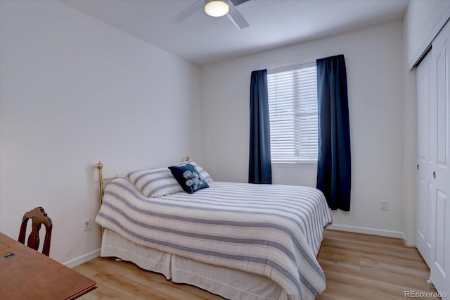 bedroom featuring a closet, wood finished floors, a ceiling fan, and baseboards