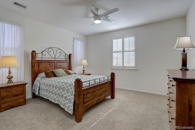 bedroom featuring baseboards, a ceiling fan, visible vents, and light colored carpet