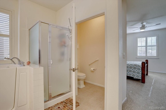 full bath with a stall shower, ceiling fan, toilet, and a bath