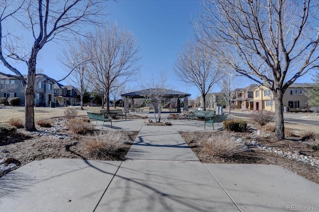 surrounding community with a residential view and a pergola