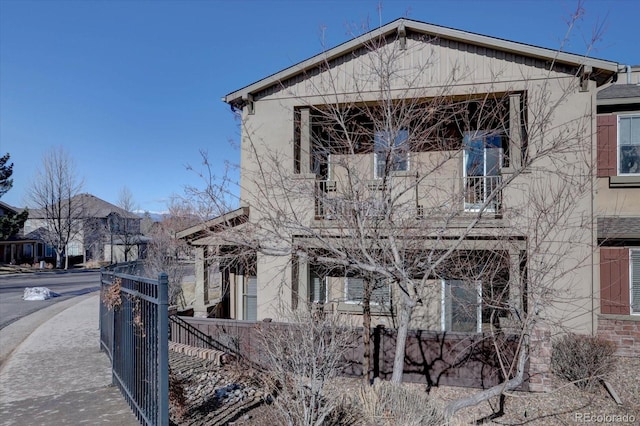 view of property exterior featuring a gate and fence