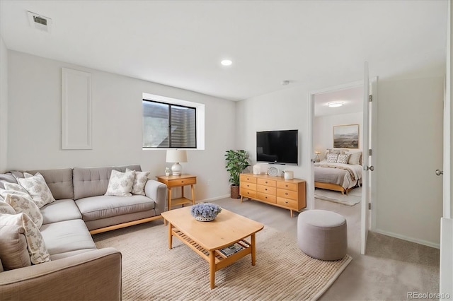 living area with baseboards, recessed lighting, visible vents, and light colored carpet