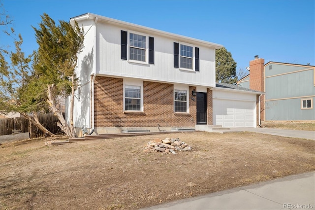 colonial home featuring a garage, concrete driveway, and brick siding