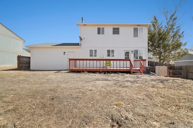 back of house featuring fence and a deck