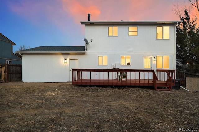 back of house with fence and a wooden deck