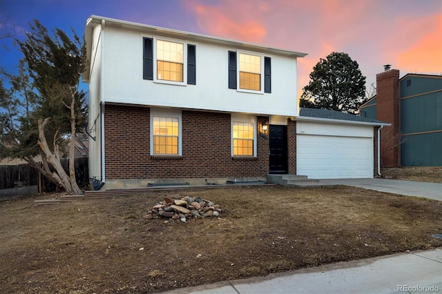 view of front of home with a garage, driveway, and brick siding