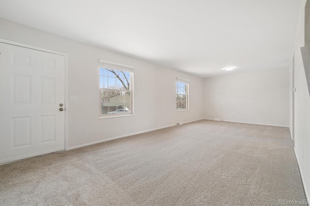 spare room with carpet and baseboards