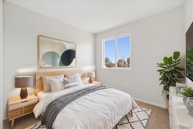 carpeted bedroom featuring baseboards