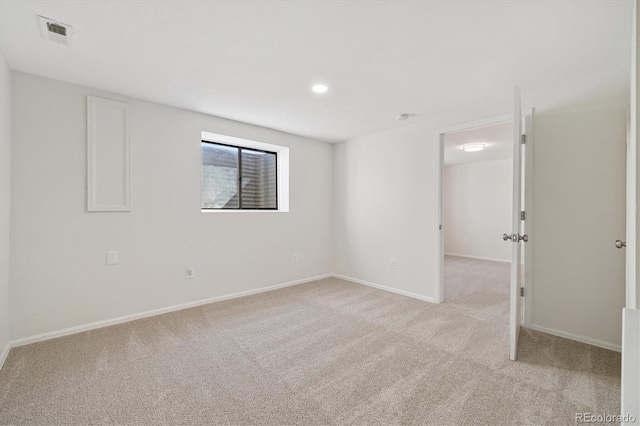 spare room featuring light carpet, baseboards, visible vents, and recessed lighting