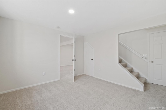 unfurnished room featuring baseboards, stairway, carpet flooring, and recessed lighting