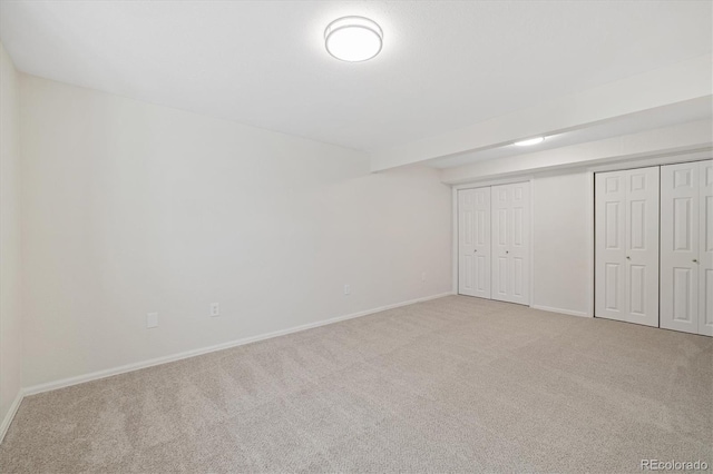 unfurnished bedroom with carpet and baseboards