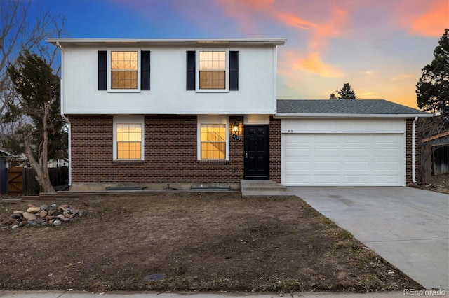 view of front of property featuring a garage, concrete driveway, brick siding, and roof with shingles