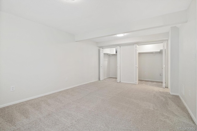 unfurnished bedroom featuring baseboards and light colored carpet