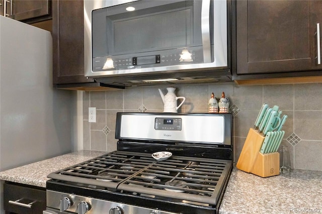 1640 Aspen Meadows Cir, Federal Heights, CO 80260 - kitchen view of stainless steel appliances, backsplash, and dark brown cabinetry