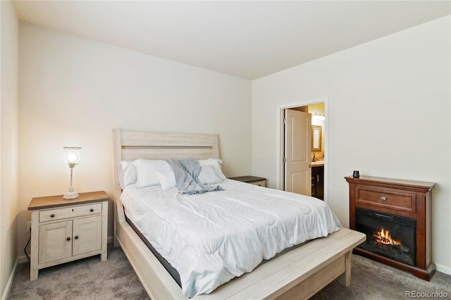 1640 Aspen Meadows Cir, Federal Heights, CO 80260 - bedroom with light carpet, a glass covered fireplace, and ensuite bath
