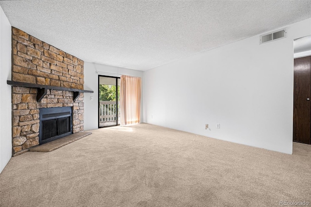 unfurnished living room featuring a fireplace, a textured ceiling, and carpet flooring