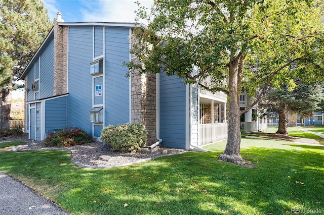 view of side of home featuring a lawn