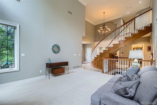 7355 Nile St, Arvada, CO 80007 - carpeted living area with a towering ceiling, stairway, a chandelier, and ornamental molding