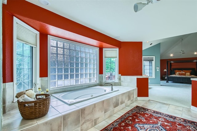 7355 Nile St, Arvada, CO 80007 - bathroom with plenty of natural light, a bath, tile patterned floors, ceiling fan, and lofted ceiling