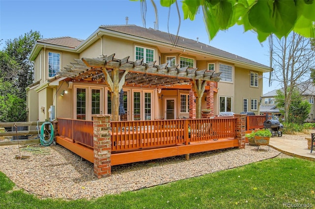 7355 Nile St, Arvada, CO 80007 - back of house featuring a pergola, stucco siding, a wooden deck, and a patio area
