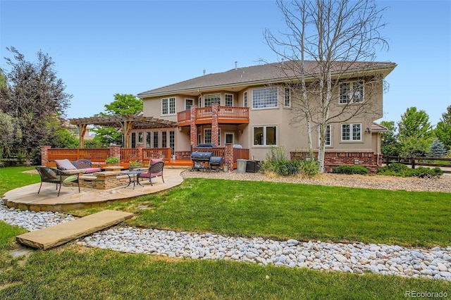 7355 Nile St, Arvada, CO 80007 - rear view of house featuring stucco siding, a pergola, an outdoor fire pit, and a yard