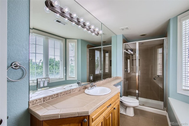 7355 Nile St, Arvada, CO 80007 - full bath with tile patterned floors, vanity, a stall shower, and healthy amount of natural light