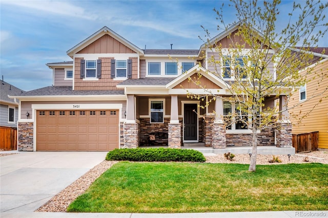 craftsman house with stone siding, a porch, a front lawn, an attached garage, and concrete driveway