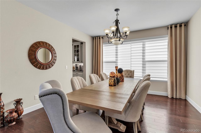 dining space with a chandelier, healthy amount of natural light, baseboards, and dark wood-style floors
