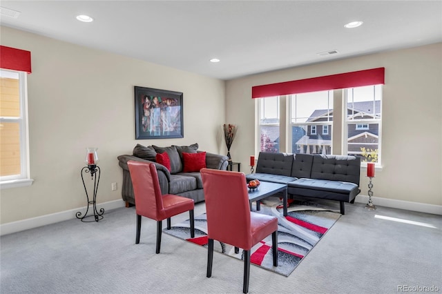 carpeted living room featuring baseboards and recessed lighting