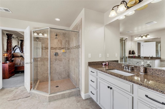 bathroom with a shower stall, ensuite bath, vanity, tile patterned floors, and baseboards