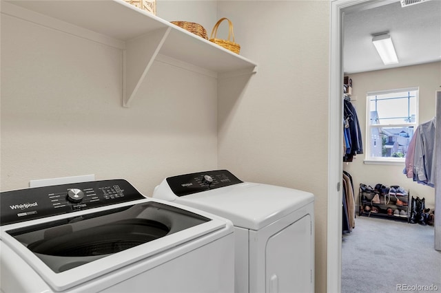 washroom with washer and dryer and carpet floors