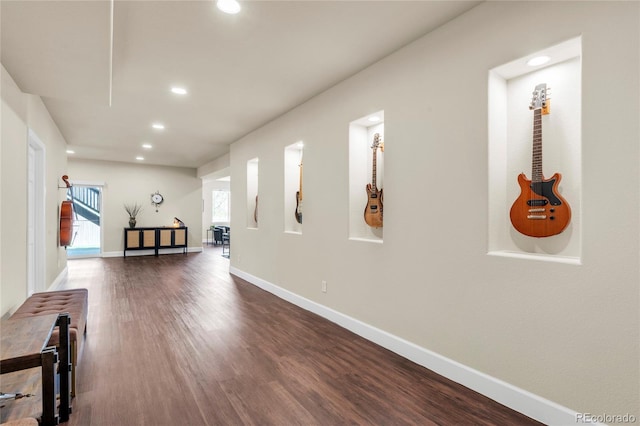 hall with recessed lighting, dark wood-type flooring, and baseboards