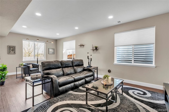 living room featuring wood finished floors, recessed lighting, and baseboards