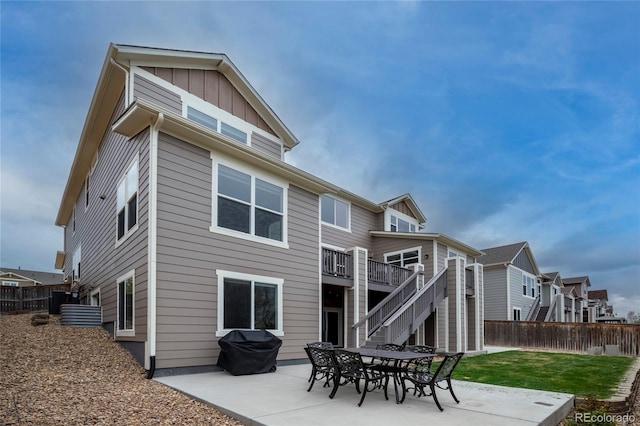 back of house featuring board and batten siding, a patio, stairway, central AC unit, and a deck